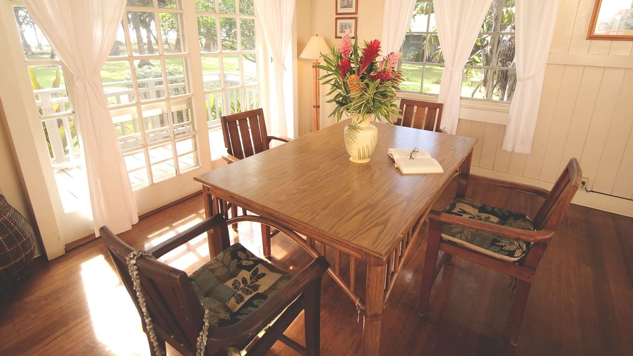 Dining room with table, chairs, and a vase