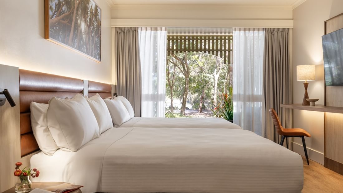 Bright deluxe room with king bed, garden view, and modern furnishings at Novotel Sunshine Coast, Twin Waters.