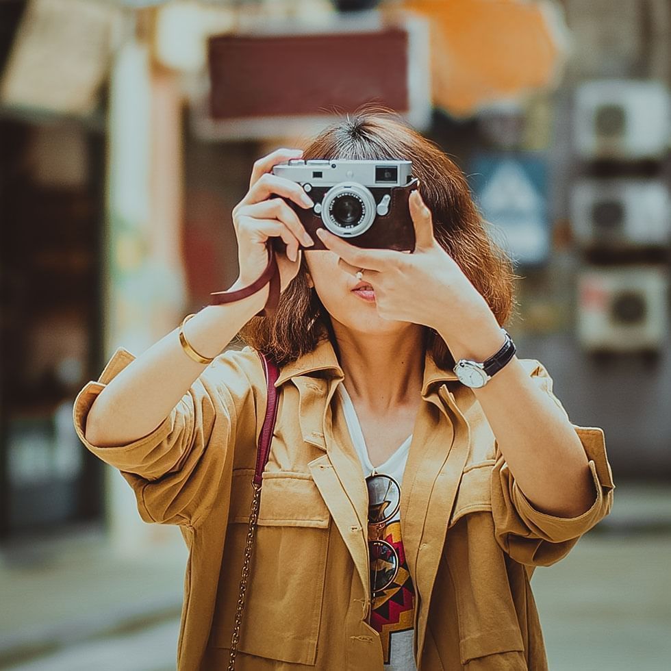 Woman taking a photo with a camera near Falkensteiner Hotel Belgrade