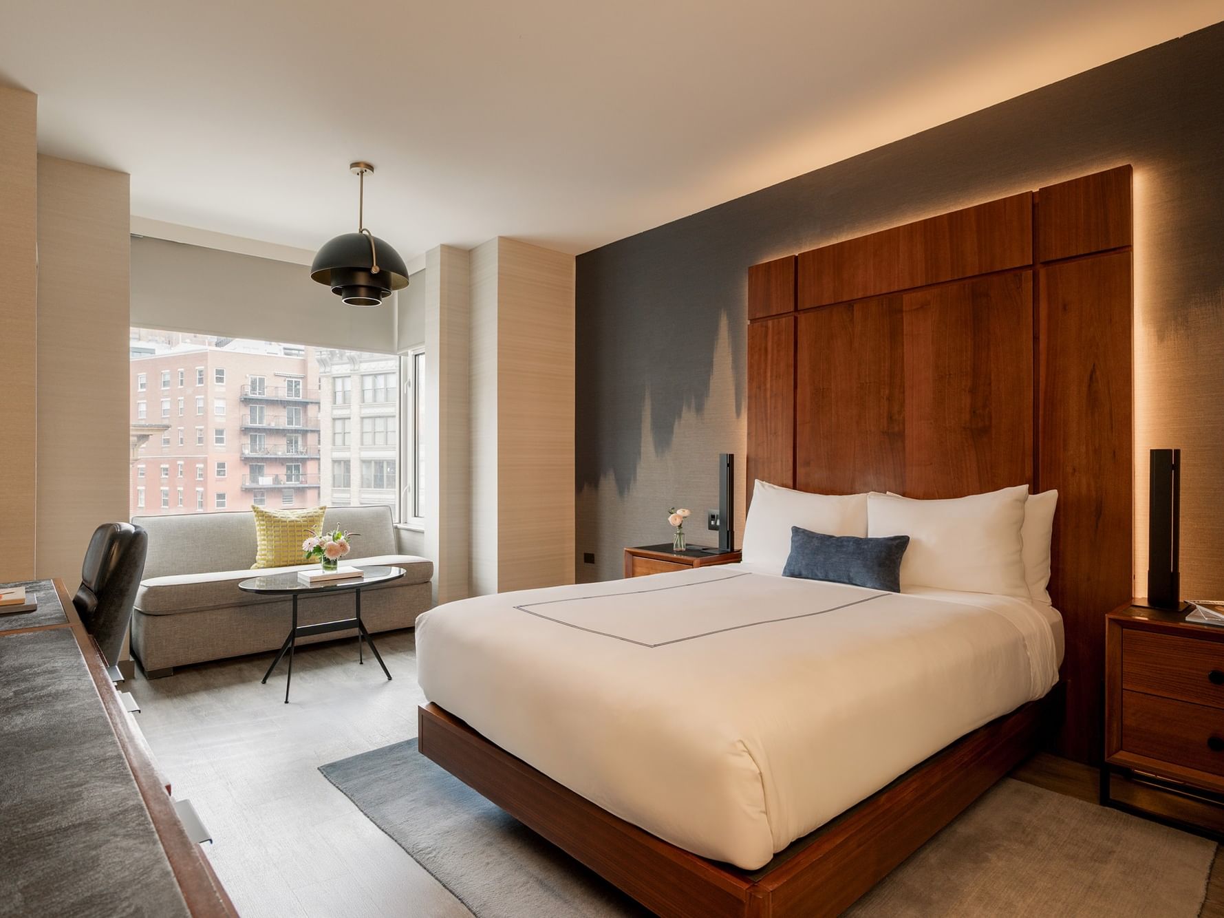 Elegant Deluxe Room with modern furniture and cityscape view at Gansevoort Meatpacking NYC in New York.