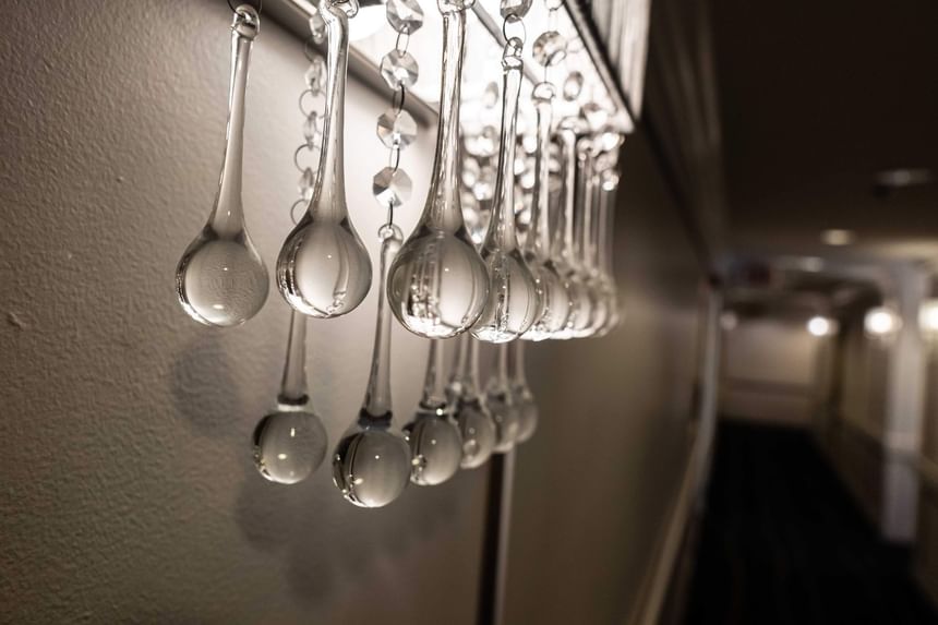Close-up of glass chandelier drops reflecting light in Hotel Bijou hallway, one of the top boutique hotels in San Francisco