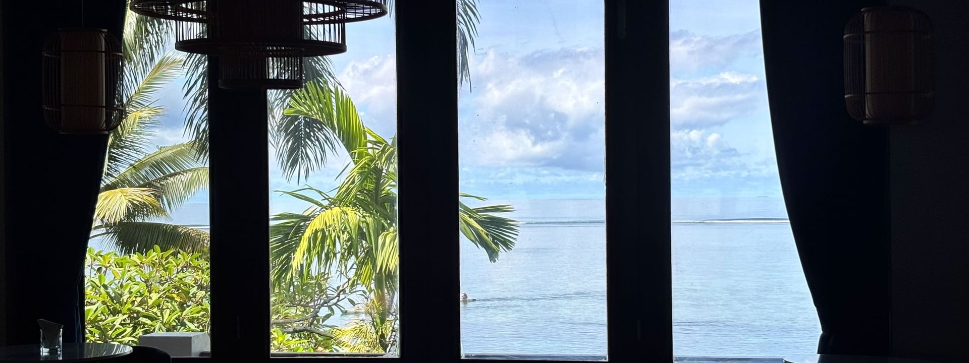View from Hibiscus Lounge at Warwick Fiji Resort and Spa, Korolevu, showing ocean and palm trees