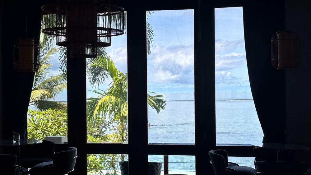 View from Hibiscus Lounge at Warwick Fiji Resort and Spa, Korolevu, showing ocean and palm trees.