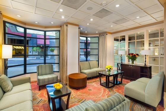 Couches, coffee tables & a pouf in the Lobby at Handlery Hotel