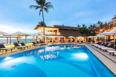 Outdoor pool area with lounges by the sea at Villa Premiere Boutique Hotel & Romantic Getaway
