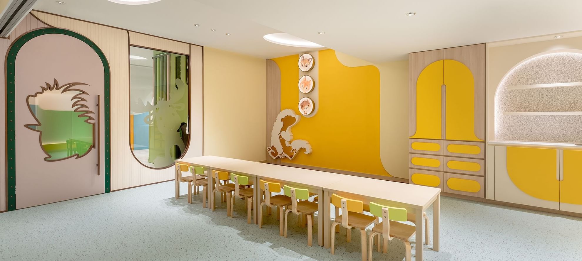 A kid's zone with a table and chairs in The Explorers at Fullerton Ocean Park Hotel Hong Kong