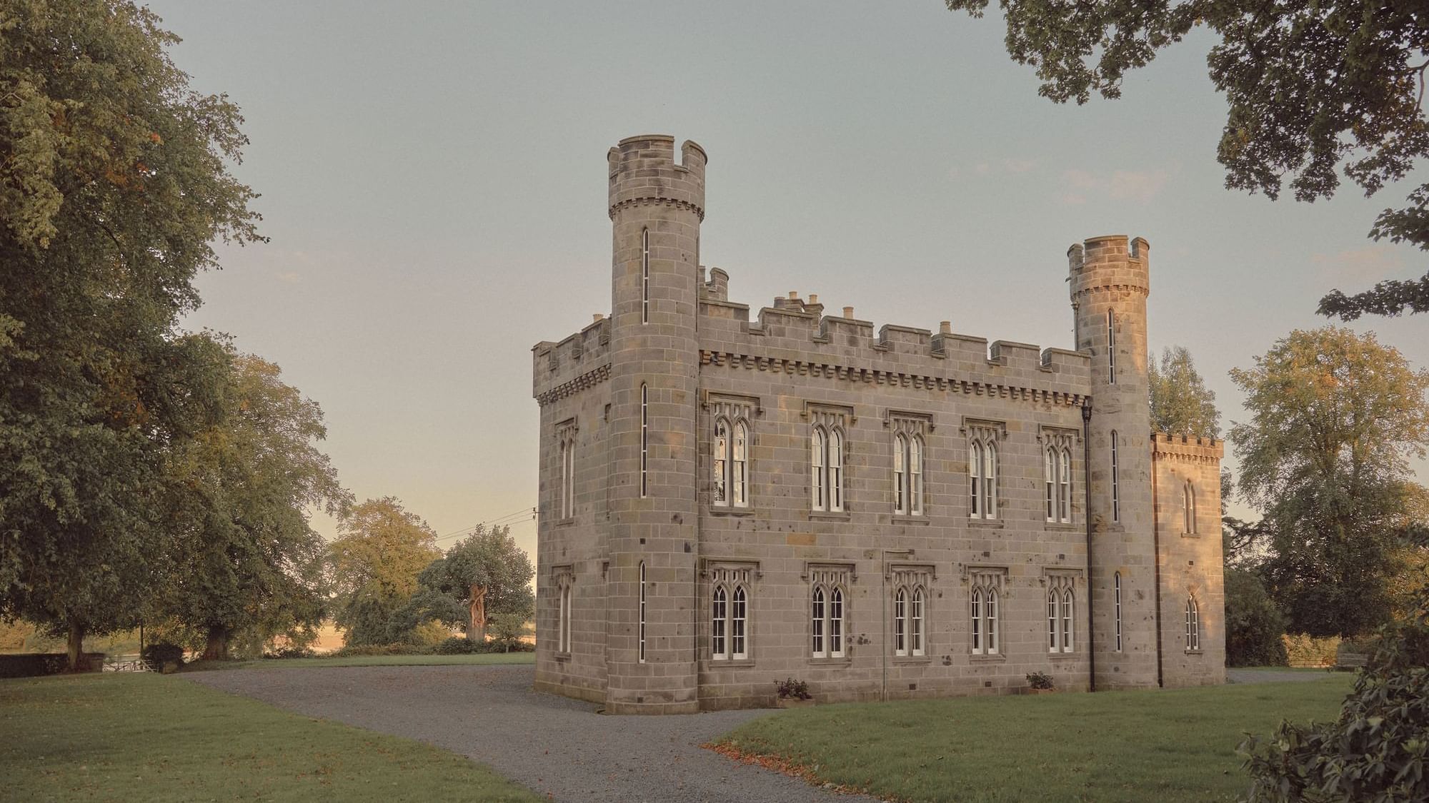 Araminta Campbell, a gray stone castle with two towers and a gravel path leading to the entrance near Seaton House
