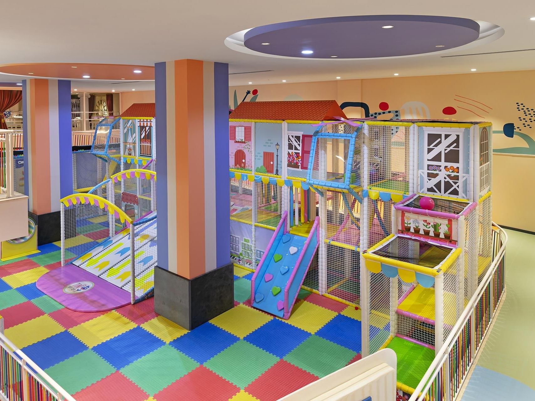 Indoor children's play area with slides, and playhouses at Titanic Deluxe Golf Belek