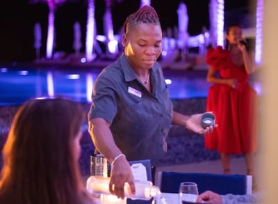Waitress serving guests drinks, The Morgan Resort Spa Village