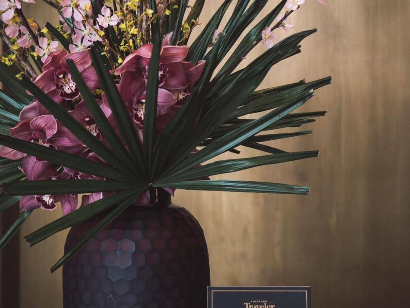 A vase of pink flowers placed on a counter table at Margutta 54