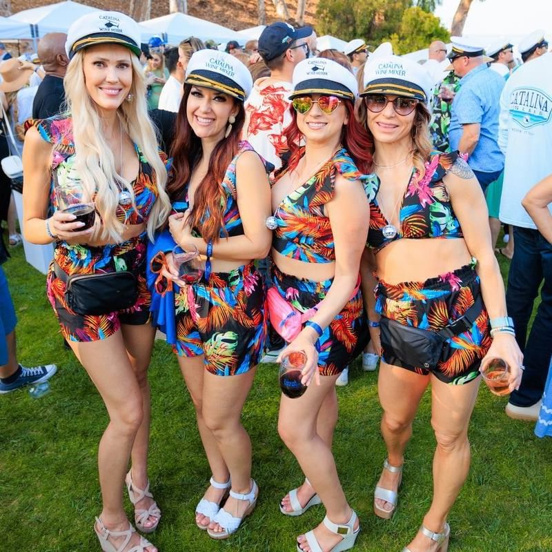 Four women in sailor hats pose together at a Catalina Wine Mixer event.