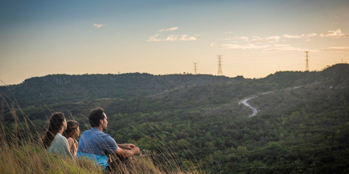 Friends overlooking the mountain ranges from a view point near Hotel Rio Perdido