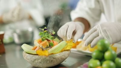 A chef decorating a dish served in restaurant at Hotel Sumaq