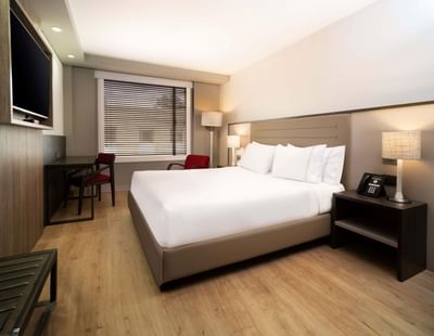 TV lounge area with workspace adjacent to the cozy bed in the Superior Queen room at Habitel Prime Hotel