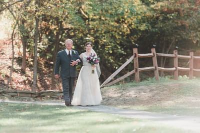 Bride being walked down to her wedding.