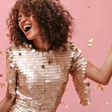 A lady enjoying a Bachelorette party with stylish clothes in a pink background at Warwick Le Crystal