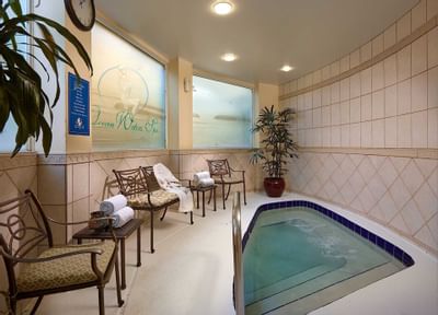 spa hot tub with chairs and towels
