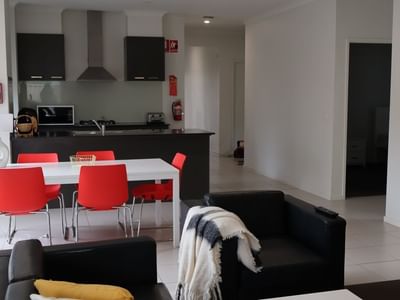 Modern living room with dining area and kitchen at La Trobe University Regional Housing.