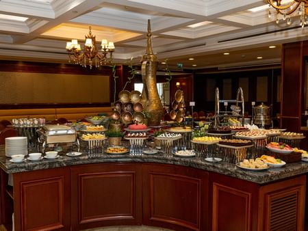 Buffet table with various dishes and desserts at Friday Brunch in Warwick Doha, Doha.