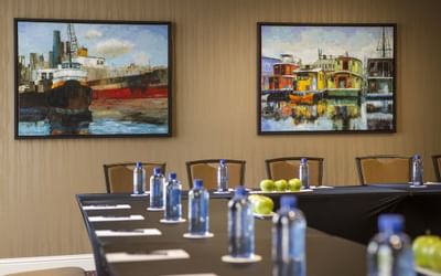 Table arranged with bottles & notepads in a meeting room at Paramount Hotel Seattle