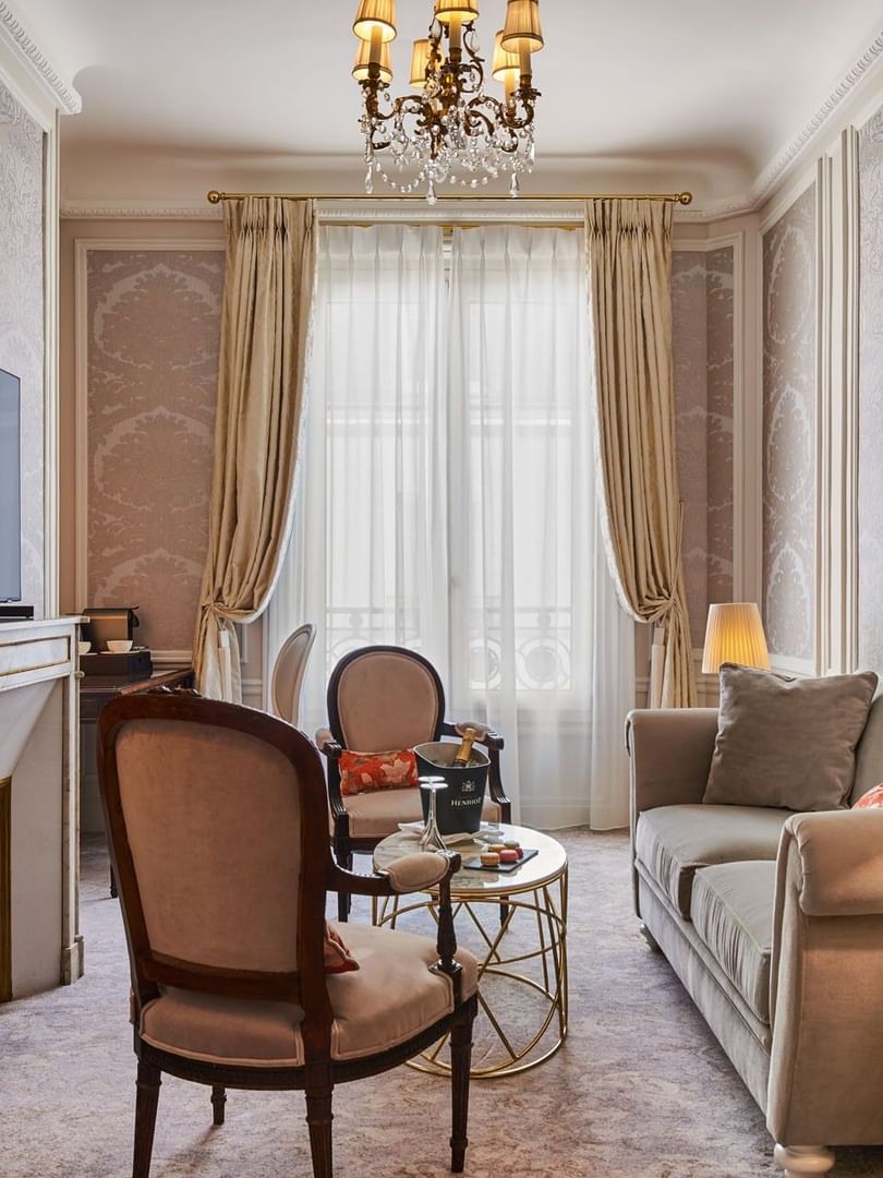 TV lounge with plush sofa near window in Deluxe Suite Belle Époque at Hotel Westminster Paris