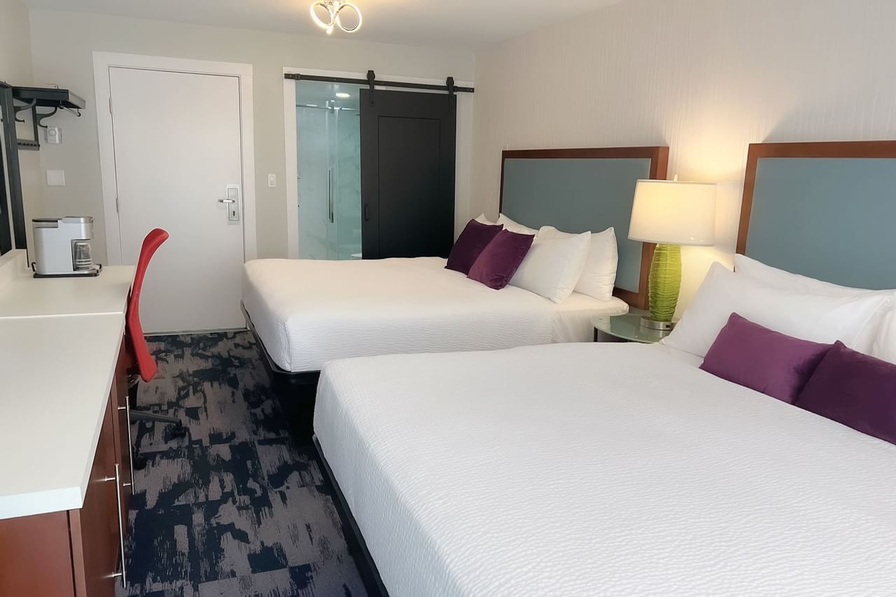 Guest room with two king beds, large desk, tv, chair