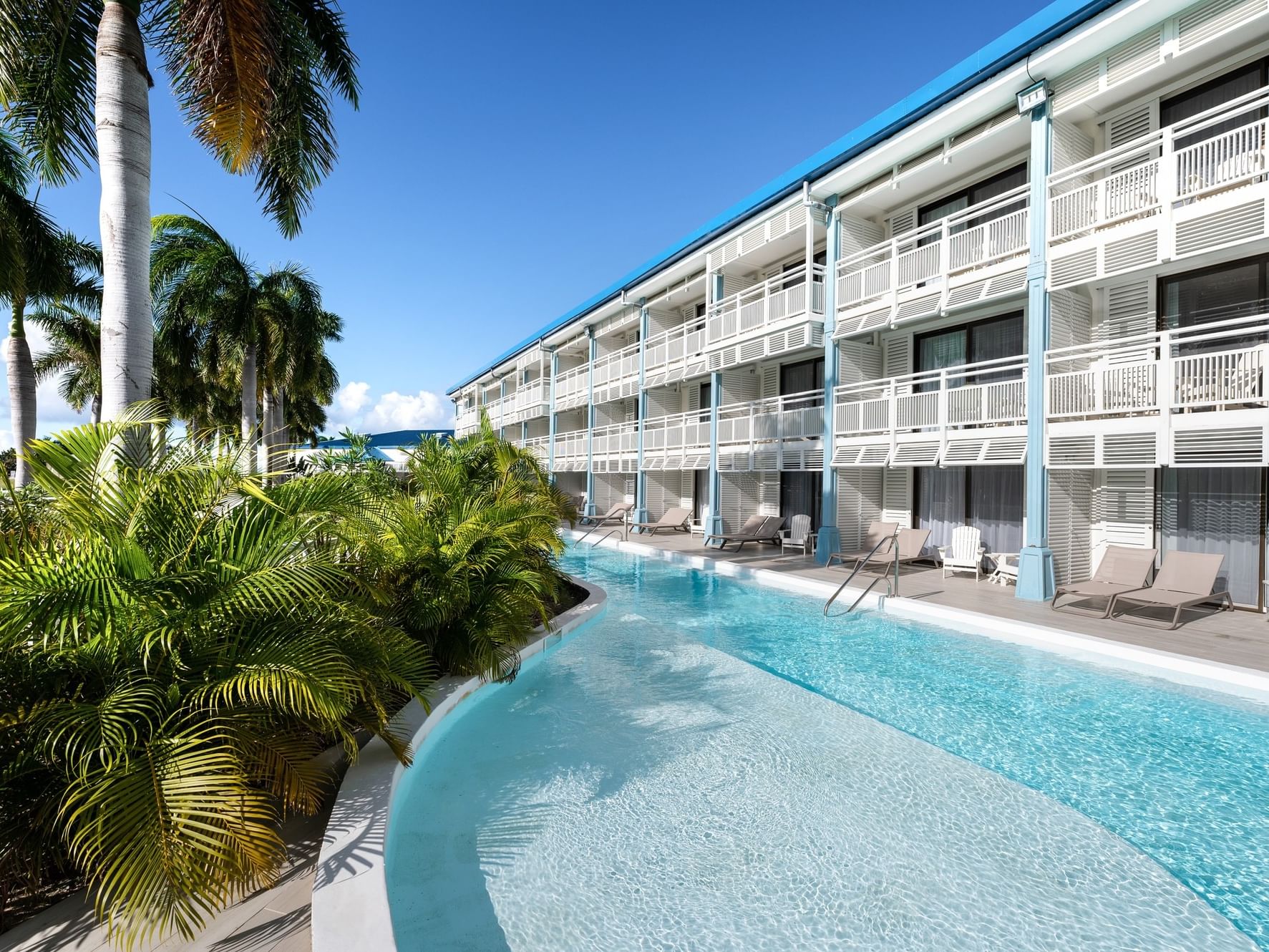 2 Room Suite Pool with sun loungers and lush greenery in Saint Martin Beach & Spa, one of the top St. Martin resorts