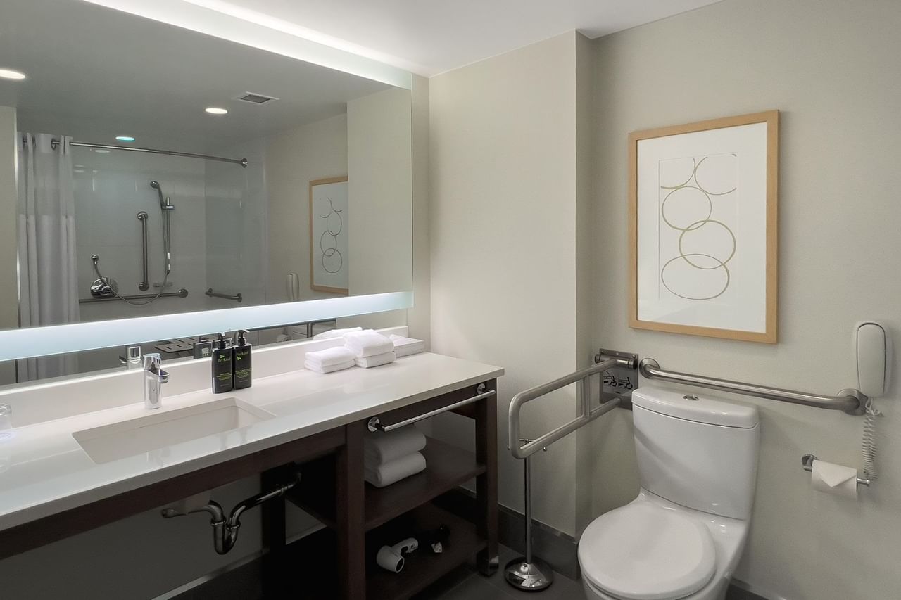 Hotel guestroom and accessible bathroom with grab bars