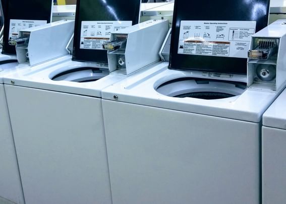 Row of open-top washing machines in the Guest Laundry at Gorges Grant Hotel