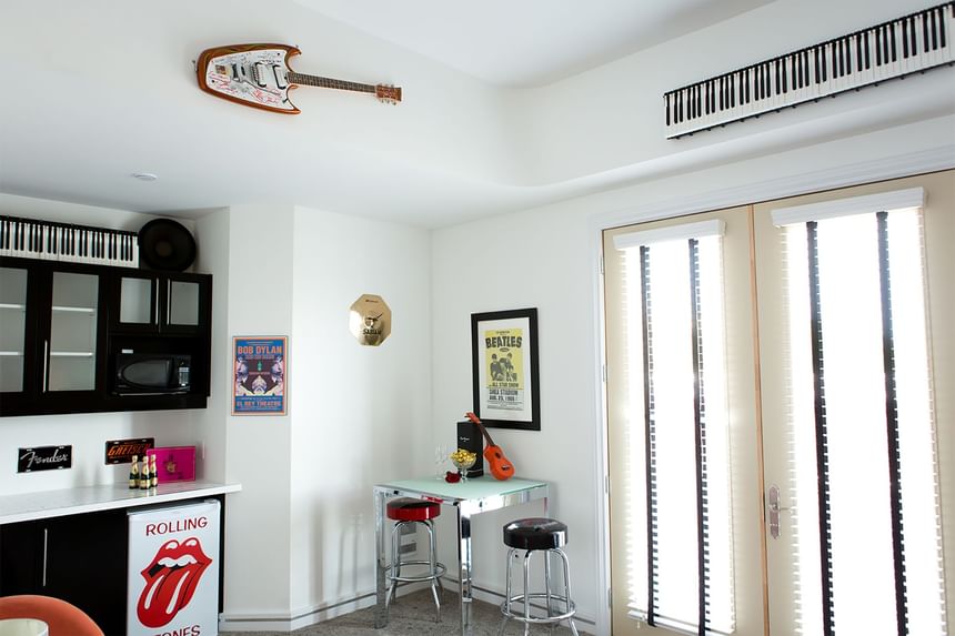 a signed guitar on the wall and a keyboard hung above the balcon