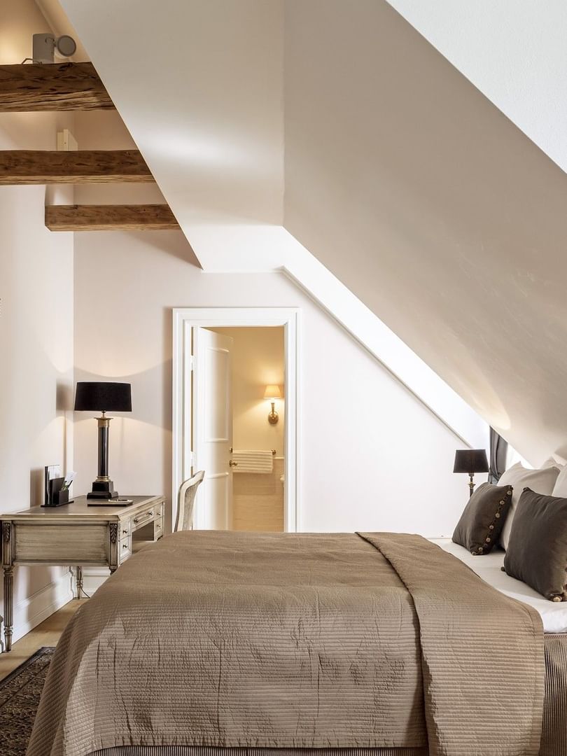 Executive room featuring large comfy bed facing wall mounted TV beside mirror with work desk at Warwick Denmark