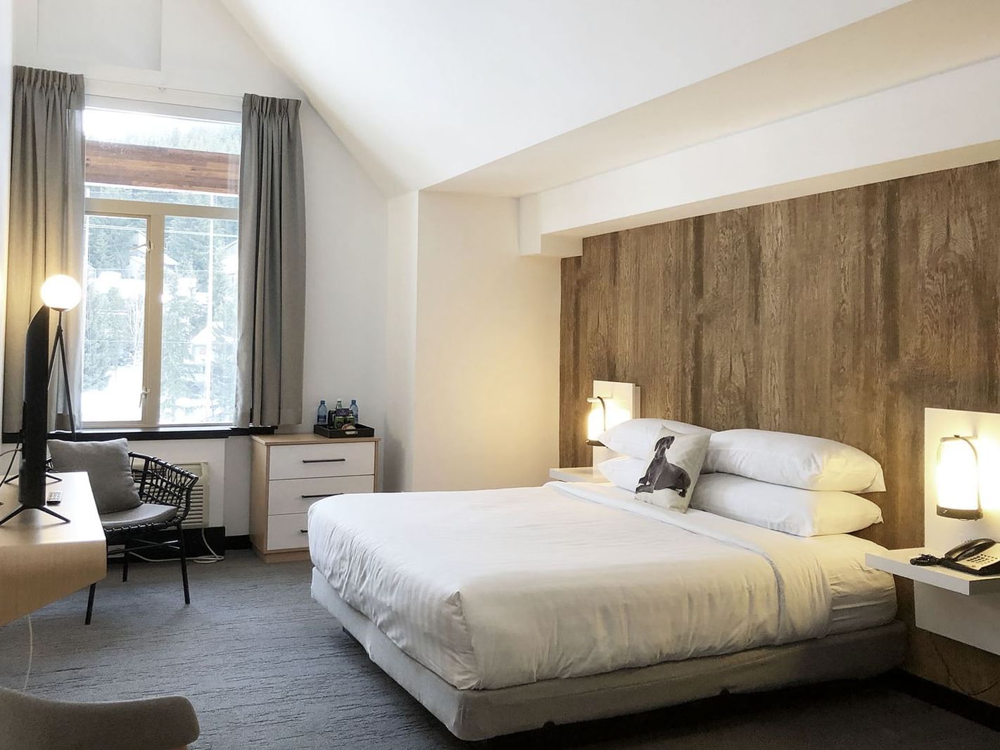Bed in hotel room with window