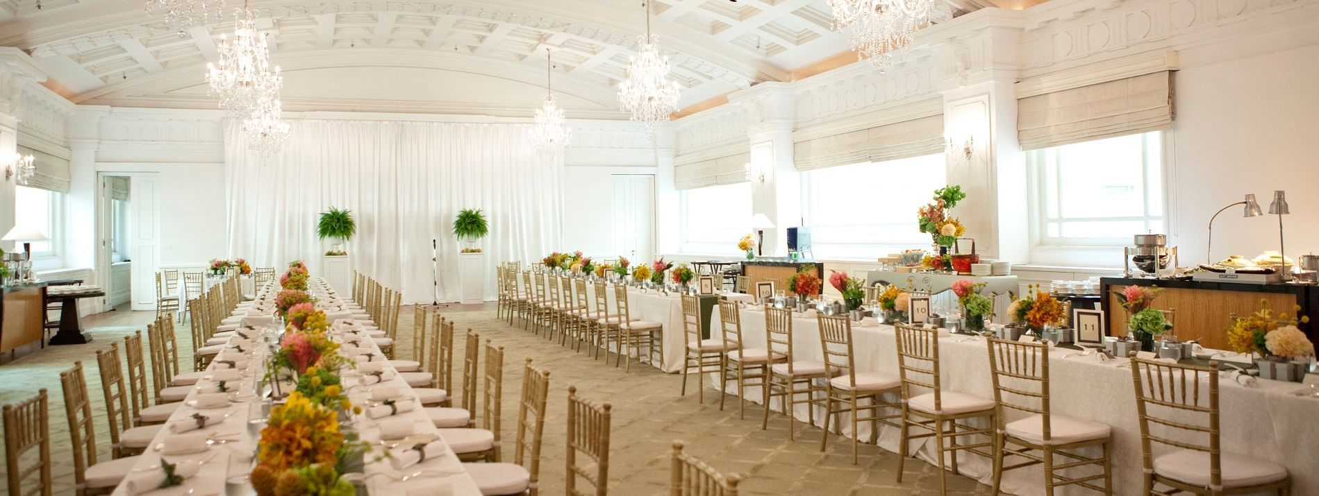The arranged Ballroom with white tables at Fullerton Hotels