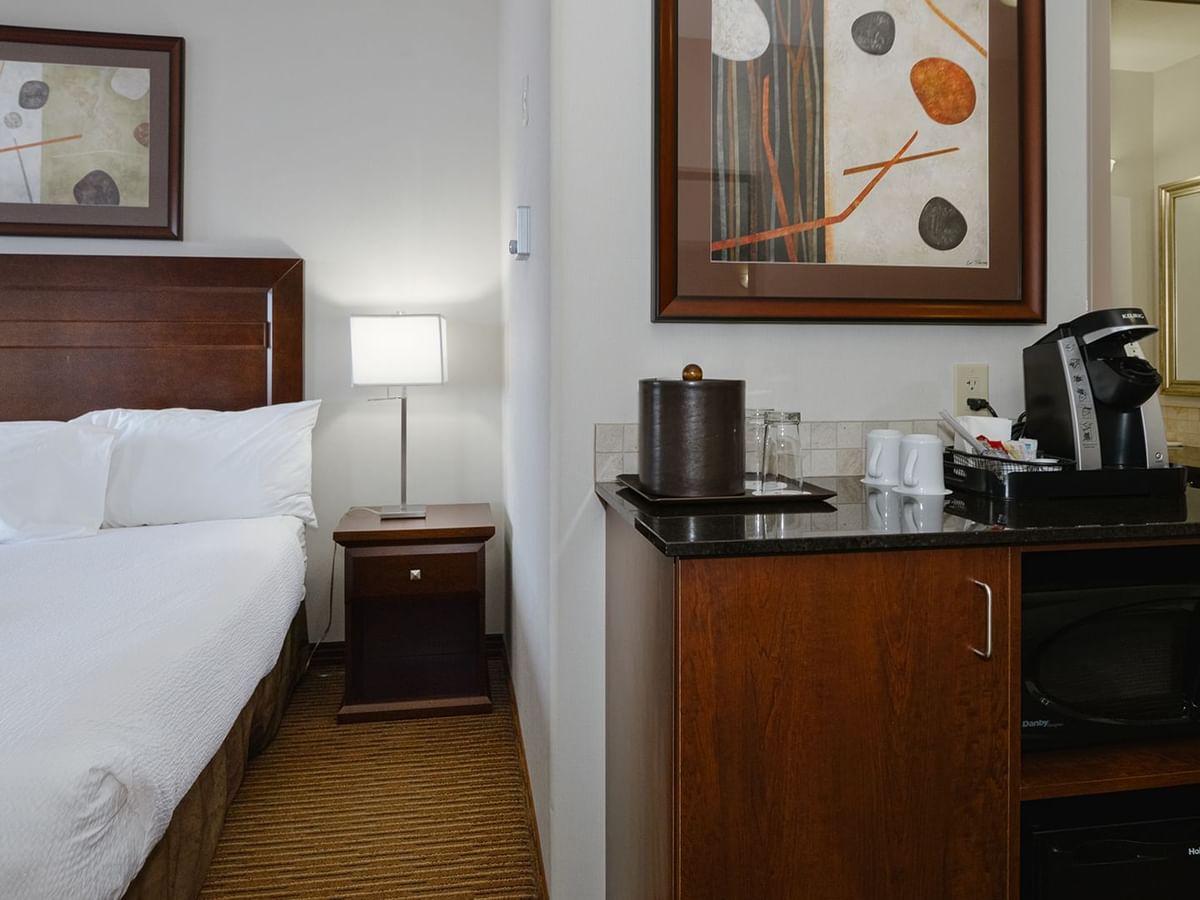 Hotel room with king bed, coffee machine, and microwave