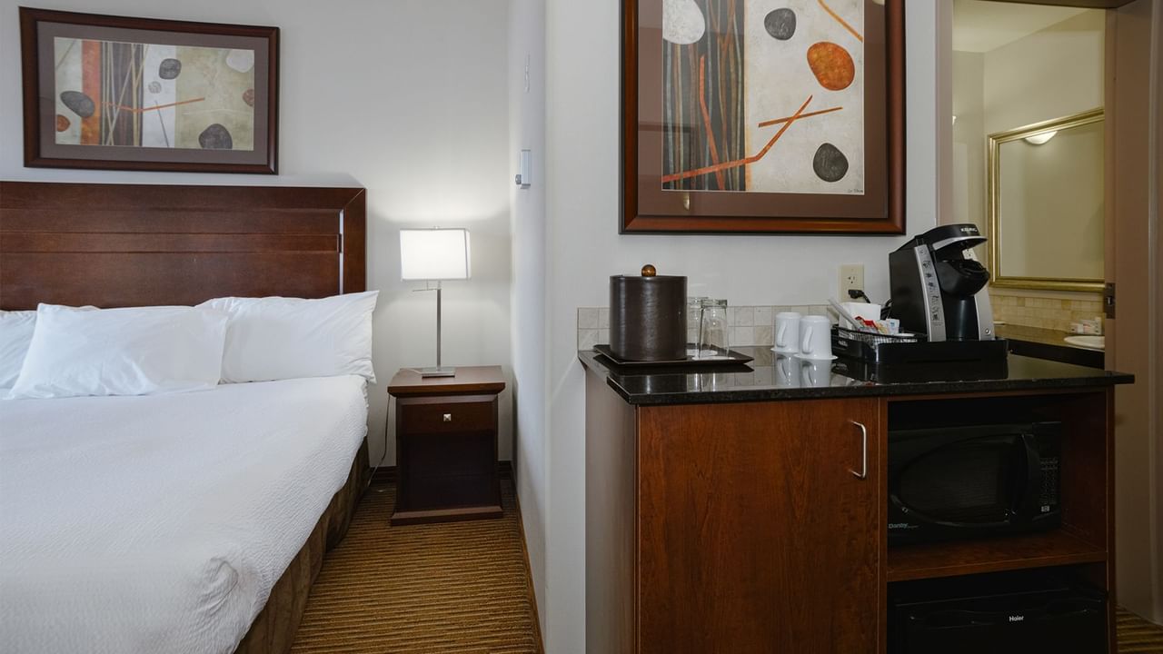 Hotel room with king bed, coffee machine, and microwave