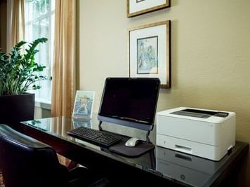 Work area with monitor and printer in Business center of Plaza Inn & Suites at Ashland Creek​