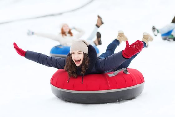 Close up on lady Winter Snow Tubing at Stein Eriksen Lodge