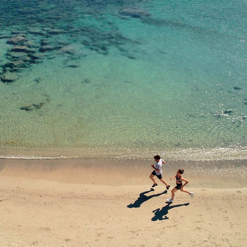 Aerial view of a couple running on the beach at Falkensteiner Premium Camping Zadar