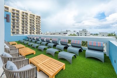 A group of chairs lined up on a rooftop terrace at Fairwind Hotel Miami