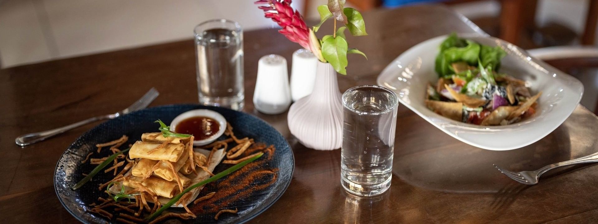 Crispy spring rolls served with sauce and fresh salad bowl in Lagoon Terrace Restaurant at warwick le lagon-vanuatu
