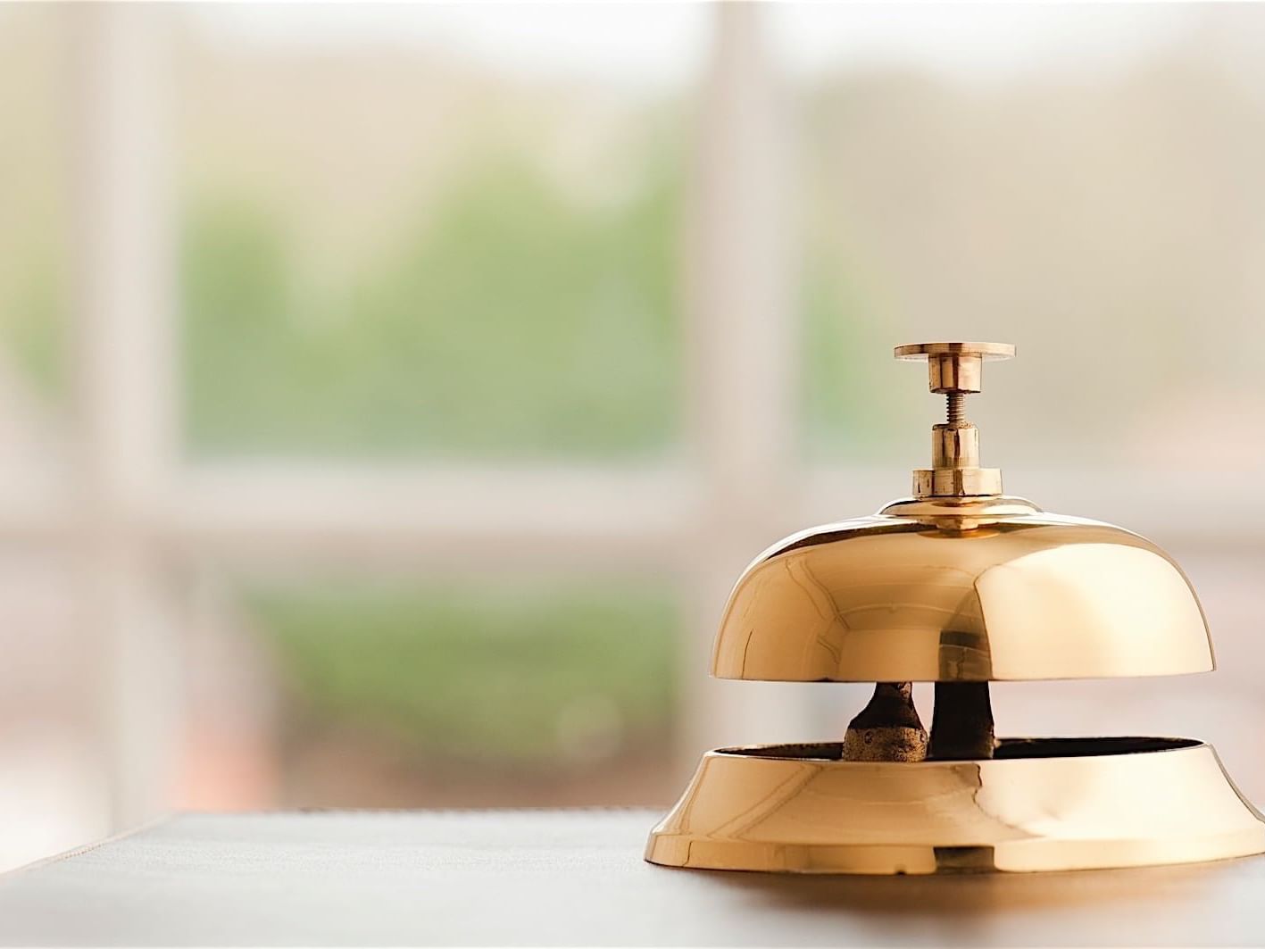 Closeup of a call bell on the front desk at Accra Hotels