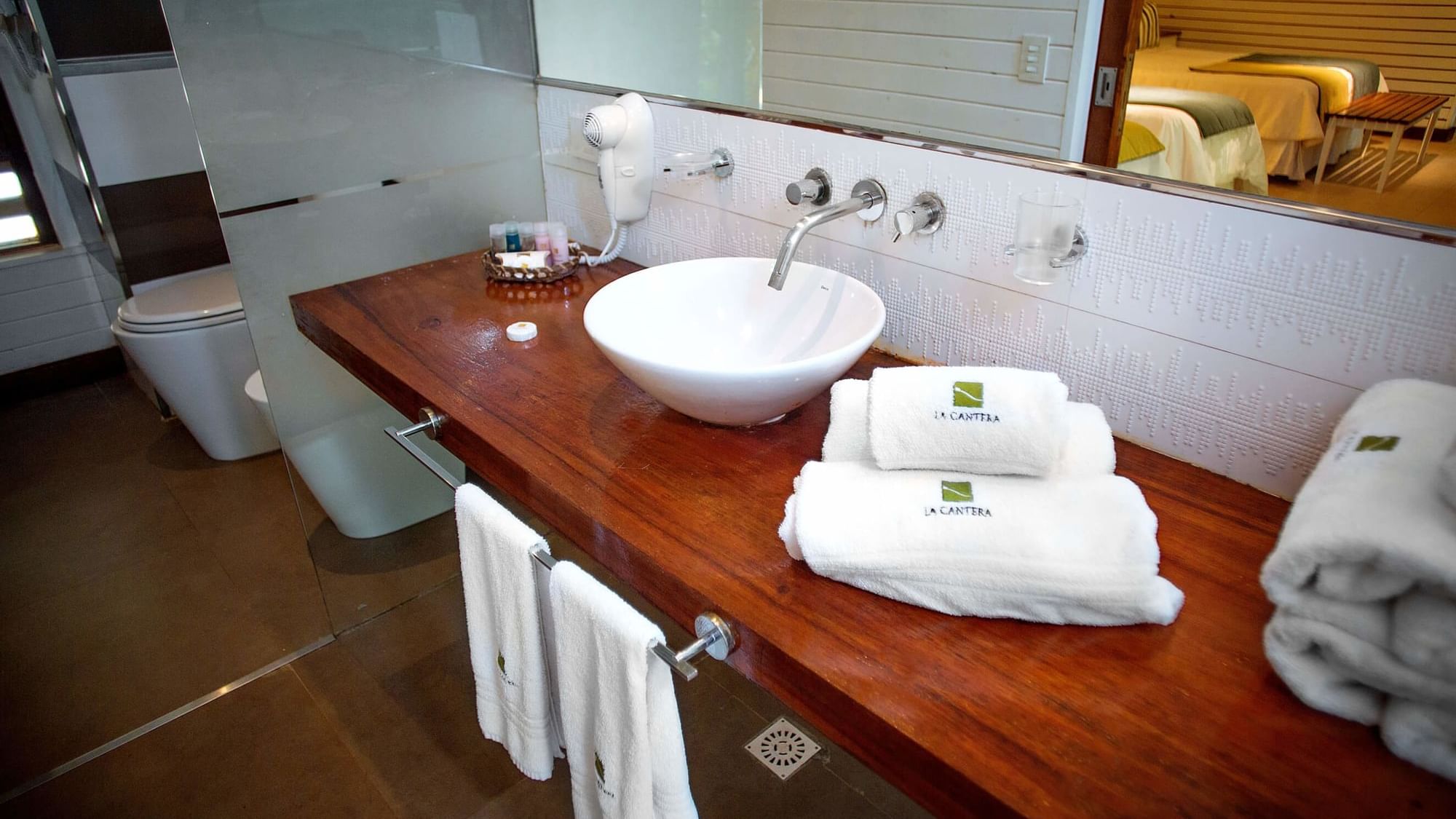 Towel rolls by the bathroom Vanity in Vila Room at DOT Hotels