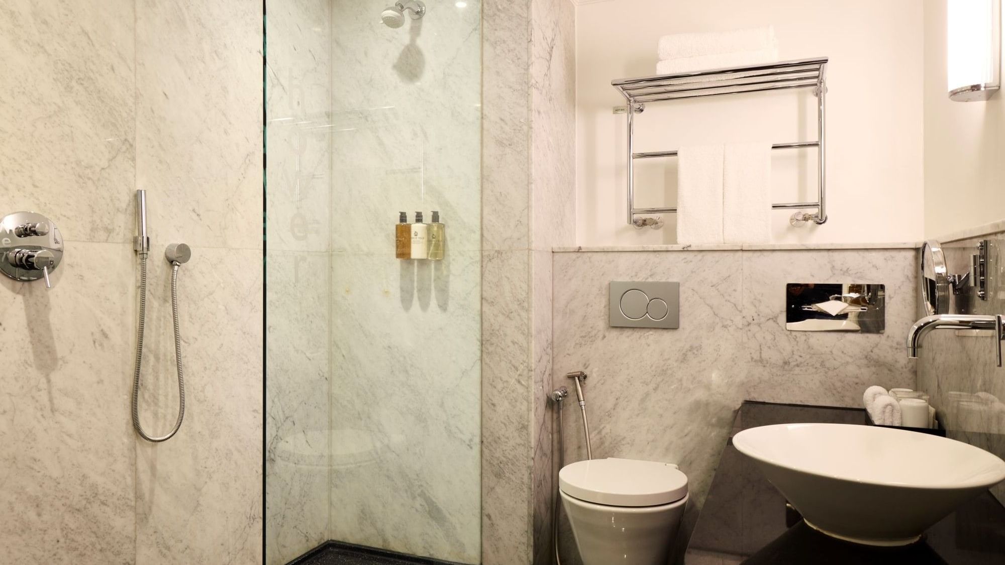Marble bathroom with glass shower, modern fixtures, and vessel sink in Collection Premium Room at The May Fair Hotel, London.