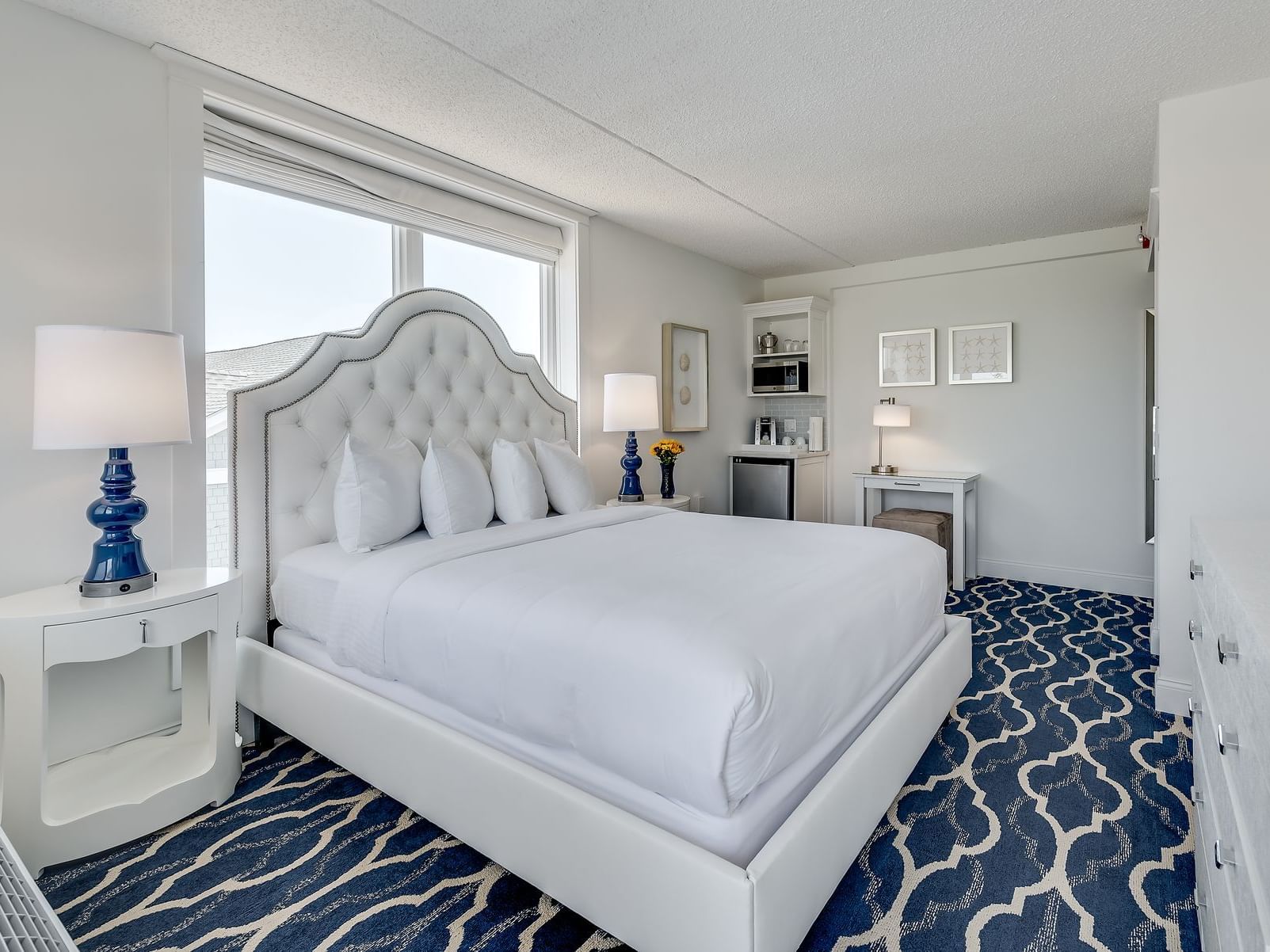 A Classic Queen room with Queen bed, microwave, and mini fridge at our Cape May hotel on the beach