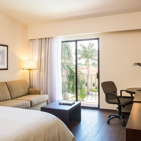 Interior of Superior Room with king bed & lounge at Fiesta Inn