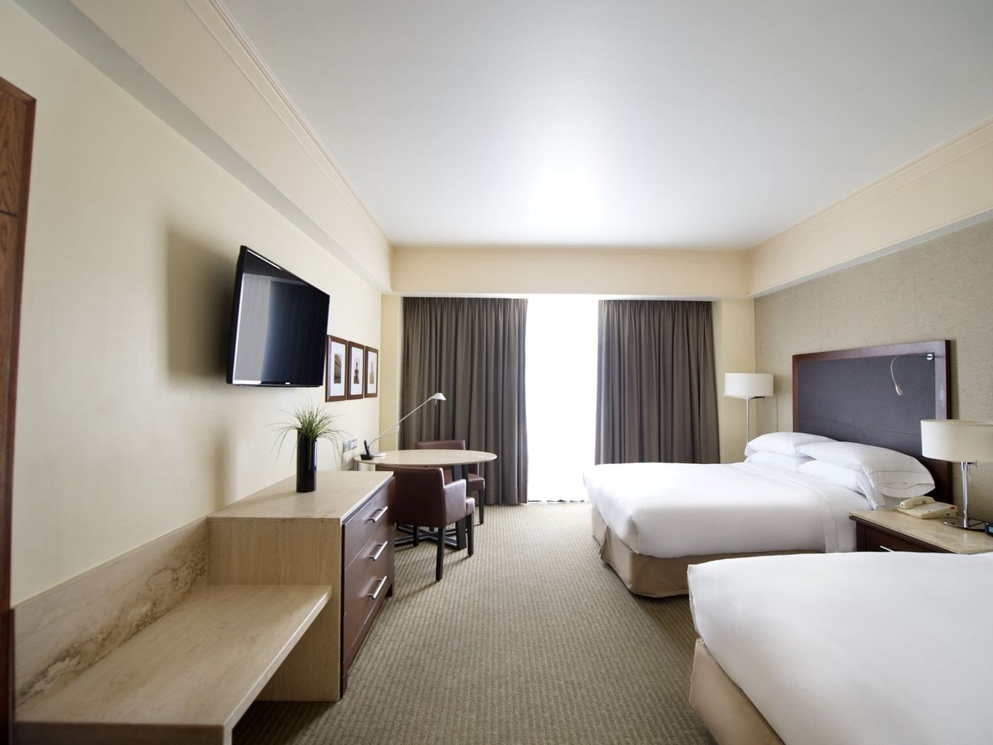 TV & bed in Deluxe Room at Grand Fiesta Americana