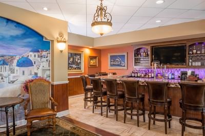 Bar with seating and mural.