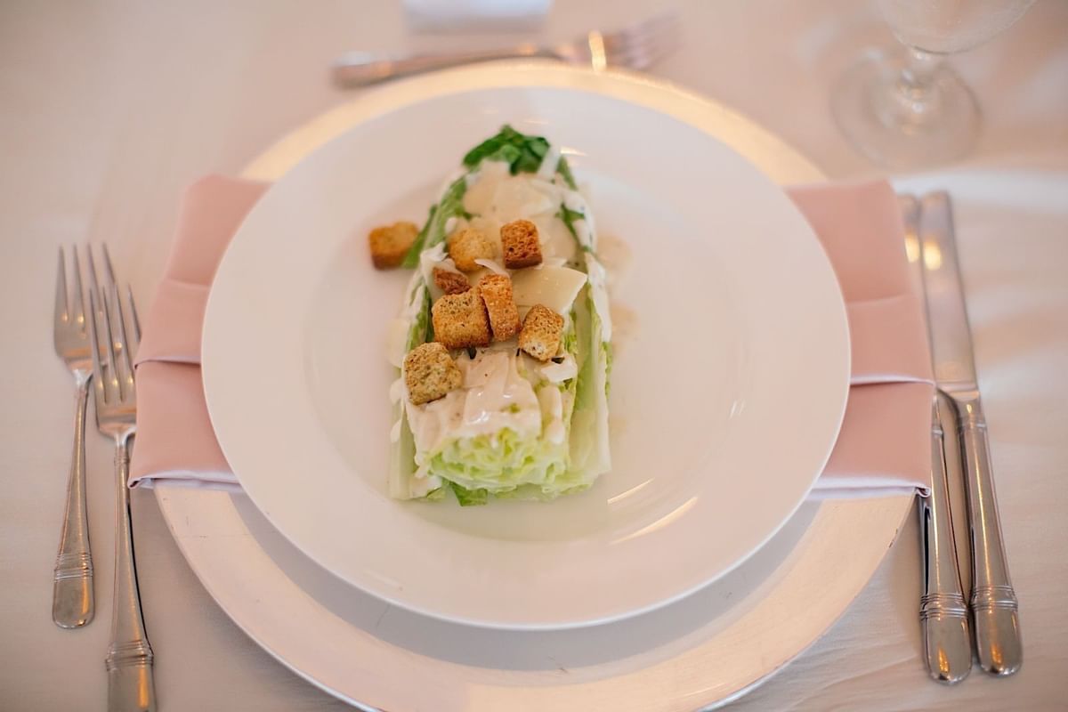 Close-up of fresh Caesar salad served at The Mayo Hotel