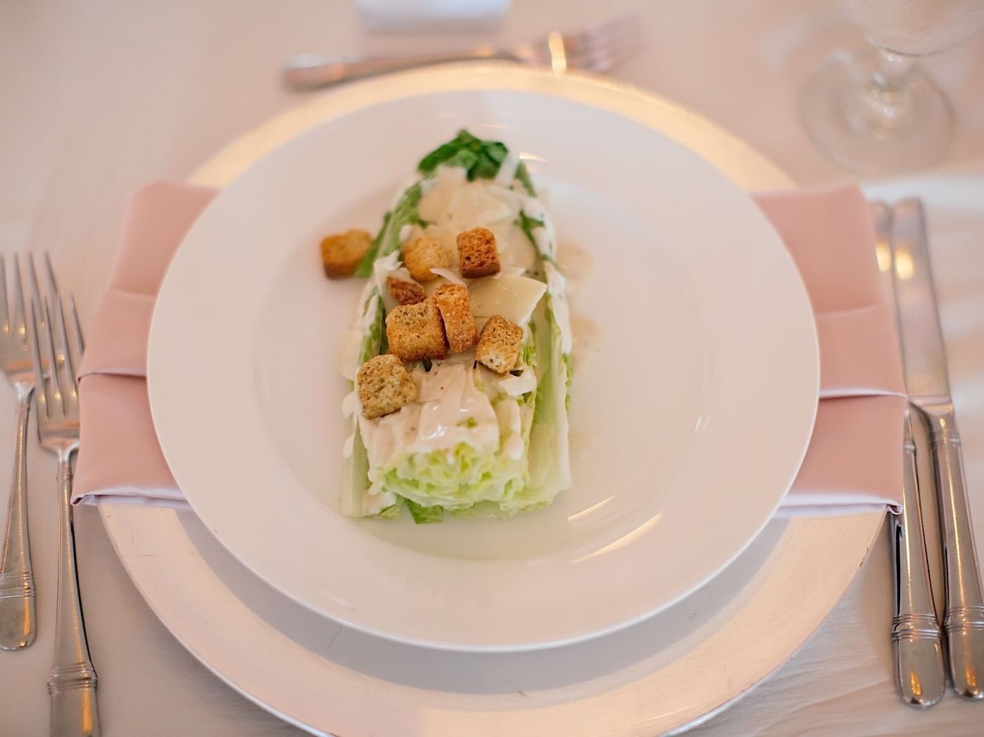 Close-up of fresh Caesar salad served at The Mayo Hotel