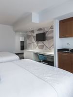 Loft Suite 2 King Beds featuring a kitchenette and work area with hanging TV at Warwick Le Crystal Montreal